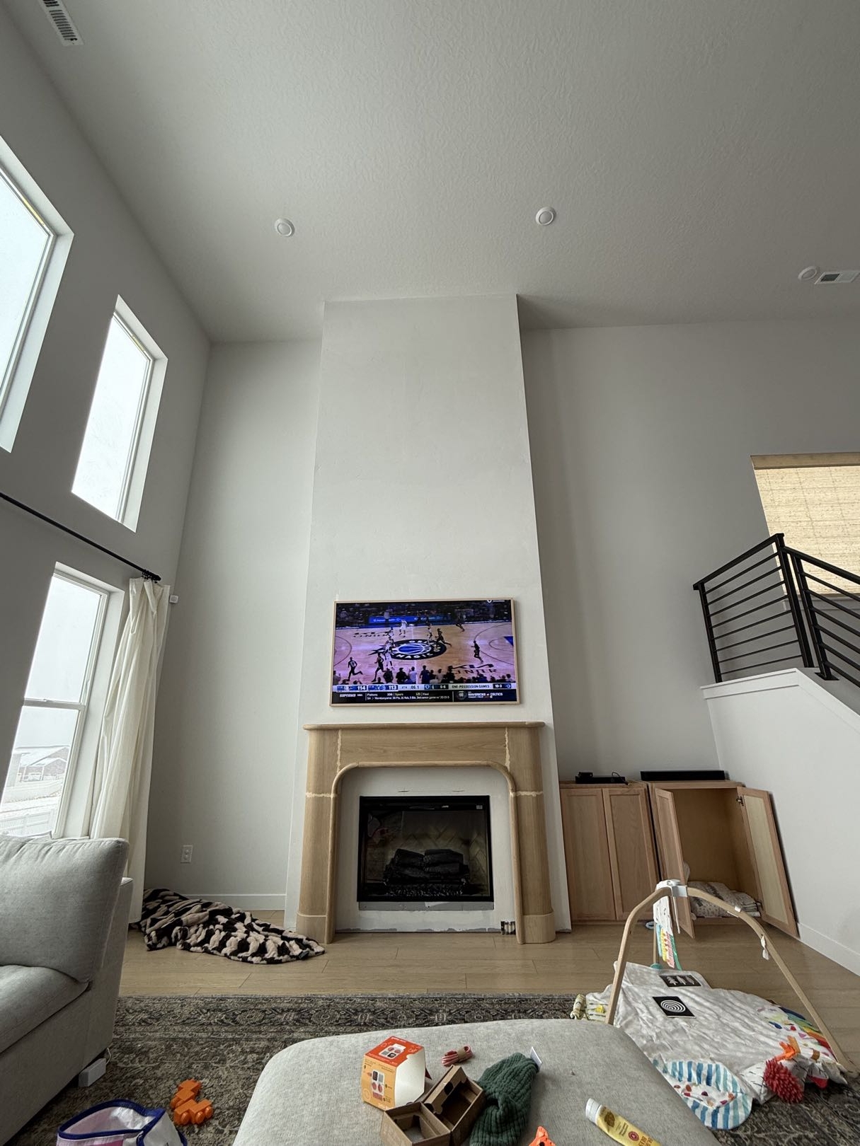 Current fireplace wall with windows left and stairs right